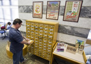 Man looking through drawer of the Seed Library