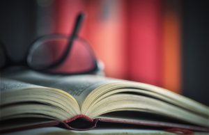 Glasses are laying on a book.