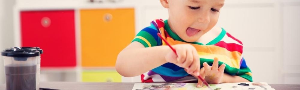 https://www.library.pima.gov/wp-content/uploads/sites/6/2020/07/wide-blog-header-birth-to-five-white-toddler-boy-painting-with-brush-tongue-out.jpg