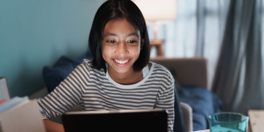 young teen female girl on laptop smiling - used for virtual volunteer - rectangle young teen female girl on laptop smiling - used for virtual volunteer - rectangle