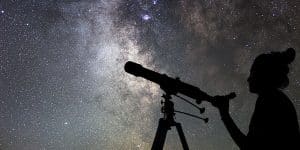 Woman and night sky. Watching the stars Woman with telescope.